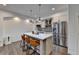 Kitchen featuring an island with seating, stainless steel appliances, and modern lighting at 828 Olmsted Ln, Duluth, GA 30097