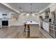 Open-concept kitchen with a large island with seating, stainless steel appliances, and modern lighting at 828 Olmsted Ln, Duluth, GA 30097