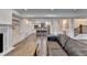 Open-concept living room with fireplace and view of kitchen featuring a large island with seating at 828 Olmsted Ln, Duluth, GA 30097