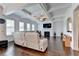 A spacious living room with a coffered ceiling, fireplace, large windows, hardwood floors, and modern furnishings at 828 Olmsted Ln, Duluth, GA 30097
