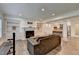 Open-concept living room with fireplace and view of kitchen featuring a large island with seating at 828 Olmsted Ln, Duluth, GA 30097