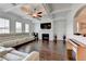 Bright living room featuring a cozy fireplace, hardwood floors, and a coffered ceiling with fan at 828 Olmsted Ln, Duluth, GA 30097