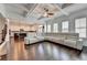 Open concept living room with hardwood floors leading to a modern kitchen area at 828 Olmsted Ln, Duluth, GA 30097