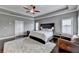 Spacious main bedroom features trey ceilings, carpet, bedside tables, and an upholstered headboard at 828 Olmsted Ln, Duluth, GA 30097