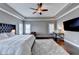 A luxurious main bedroom features a tray ceiling, plush rug, and ample natural light at 828 Olmsted Ln, Duluth, GA 30097