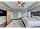 This lovely main bedroom has hardwood floors, bedside tables, and trey ceilings at 828 Olmsted Ln, Duluth, GA 30097