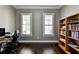 Spacious home office featuring hardwood floors, dual windows and a custom built-in bookcase at 828 Olmsted Ln, Duluth, GA 30097