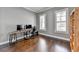 Spacious home office featuring hardwood floors, dual windows and a custom built-in bookcase at 828 Olmsted Ln, Duluth, GA 30097