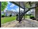 Covered patio with stone floor and staircase provides a relaxing outdoor space at 828 Olmsted Ln, Duluth, GA 30097