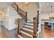 A beautiful staircase with hardwood treads, white risers, and dark iron railings leads to the upper level at 828 Olmsted Ln, Duluth, GA 30097