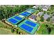 Aerial view of community tennis courts, perfect for recreation and exercise, surrounded by lush greenery at 828 Olmsted Ln, Duluth, GA 30097