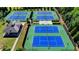Multiple community tennis courts are seen from an aerial perspective, each meticulously maintained and ready for play at 828 Olmsted Ln, Duluth, GA 30097