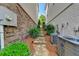 Brick walkway between homes with landscaping and AC units at 828 Olmsted Ln, Duluth, GA 30097