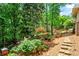 Landscaped backyard with mature trees and stone pathway at 1075 Winding Branch Ln, Atlanta, GA 30338