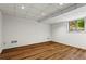 Finished basement with laminate floors, window view, and recessed lighting at 1075 Winding Branch Ln, Atlanta, GA 30338