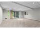 Finished basement area with sliding door access and neutral carpet at 1075 Winding Branch Ln, Atlanta, GA 30338