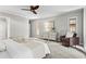Bright bedroom with two sunny windows, a ceiling fan, and a comfortable seating area at 1075 Winding Branch Ln, Atlanta, GA 30338