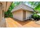Wide outdoor deck with exterior entrance and view of landscaping at 1075 Winding Branch Ln, Atlanta, GA 30338