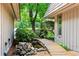 Scenic front entrance with a wooden walkway over a koi pond and rock garden leading to the front door at 1075 Winding Branch Ln, Atlanta, GA 30338