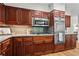 Well-appointed kitchen with stainless steel appliances, wood cabinets, and granite countertops at 1075 Winding Branch Ln, Atlanta, GA 30338