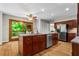 Eat in kitchen with granite countertops, wood cabinets and access to an outdoor deck area at 1075 Winding Branch Ln, Atlanta, GA 30338