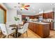 Open kitchen featuring stainless steel appliances, wood cabinets, large island, and adjacent dining area at 1075 Winding Branch Ln, Atlanta, GA 30338