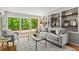 Comfortable living room area with built-in shelving and sliding doors to a relaxing outdoor deck at 1075 Winding Branch Ln, Atlanta, GA 30338