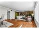 Bright living room featuring hardwood floors, stone accent wall, and sliding door access to outdoor living at 1075 Winding Branch Ln, Atlanta, GA 30338