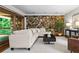 Cozy living room featuring a stone wall, comfortable seating, and a bright, airy atmosphere at 1075 Winding Branch Ln, Atlanta, GA 30338