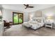 Relaxing main bedroom with a ceiling fan, backyard view and comfortable seating at 1075 Winding Branch Ln, Atlanta, GA 30338