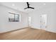A basement bedroom features light wood floors, white walls, a window, and doors to a closet and ensuite bathroom at 1287 Star Ne Dr, Brookhaven, GA 30319