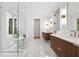 Bright and luxurious bathroom featuring double vanity, glass shower, soaking tub, and marble floors at 1287 Star Ne Dr, Brookhaven, GA 30319
