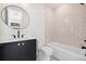 Elegant bathroom showcases a round mirror, black fixtures, and white tile, exuding modern luxury at 1287 Star Ne Dr, Brookhaven, GA 30319