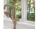 Elegant bathtub faucet with a nearby window that offers beautiful outdoor views in this spa-like bathroom at 1287 Star Ne Dr, Brookhaven, GA 30319