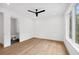 Bright bedroom features hardwood floors, a modern ceiling fan and ample natural light through a large window at 1287 Star Ne Dr, Brookhaven, GA 30319