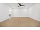 A spacious bedroom with light wood floors, white walls, a ceiling fan, and ample natural light at 1287 Star Ne Dr, Brookhaven, GA 30319