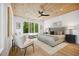 Stylish bedroom with wood-paneled ceiling, ceiling fan, large window with green view, and neutral color palette at 1287 Star Ne Dr, Brookhaven, GA 30319