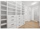Walk-in closet with custom built-in shelving, cabinets, and drawers for optimal storage and organization at 1287 Star Ne Dr, Brookhaven, GA 30319