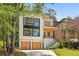 Modern home with a two-car garage and a combination of light-colored siding and wood panels at 1287 Star Ne Dr, Brookhaven, GA 30319