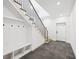 A bright foyer with tile floors, stairs with metal railings, a skylight, and custom storage solutions at 1287 Star Ne Dr, Brookhaven, GA 30319