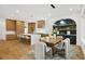 Gourmet kitchen and dining area with modern cabinetry, hardwood floors, and stylish light fixtures at 1287 Star Ne Dr, Brookhaven, GA 30319