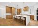 Well-lit kitchen with an island featuring white counter tops, modern lighting, and lots of seating at 1287 Star Ne Dr, Brookhaven, GA 30319