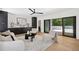 Bright living room boasts modern furniture, sleek built-ins, and access to an outdoor patio for seamless indoor-outdoor living at 1287 Star Ne Dr, Brookhaven, GA 30319