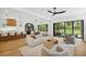 Open-concept living area with hardwood floors, modern furnishings, and an open view of the backyard at 1287 Star Ne Dr, Brookhaven, GA 30319