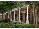 Commercial retail space featuring brick facade, white columns, and lush landscaping for a welcoming appearance at 1287 Star Ne Dr, Brookhaven, GA 30319