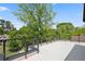 A modern rooftop deck with metal railings and views of the surrounding neighborhood and foliage at 1287 Star Ne Dr, Brookhaven, GA 30319