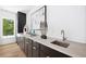 Elegant wet bar with sleek cabinetry, marble countertops, and stylish decor, perfect for entertaining guests at 1287 Star Ne Dr, Brookhaven, GA 30319