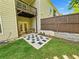 Inviting outdoor living space with a charming patio, lush lawn, and a privacy fence at 150 Holden Way, Woodstock, GA 30189