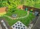 Overhead view of a fenced backyard featuring a stone patio, green lawn, and a tree at 150 Holden Way, Woodstock, GA 30189