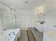 Bathroom featuring a glass-enclosed shower, soaking tub, double sinks and tile flooring for a clean, modern look at 150 Holden Way, Woodstock, GA 30189